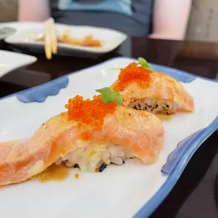 On house torched salmon nigiri for regulars!