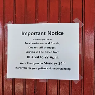 a sign posted on a red door