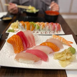 a woman eating sushi at a restaurant