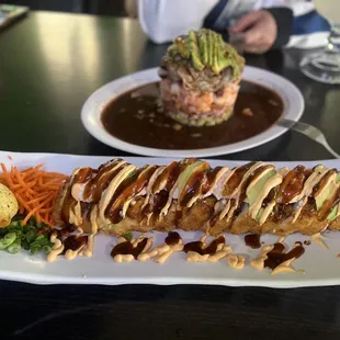 a plate of sushi and a plate of vegetables