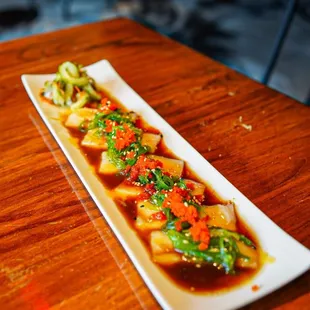 a long rectangular plate of sushi