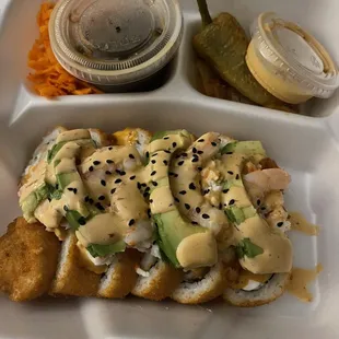 a tray with a sandwich and a pickle