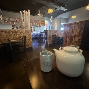 a teapot and two cups on a table