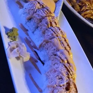 Mango Tanger Roll- Crawfish, Mango, &amp; Avocado topped with Spicy Scallop and CrabMeat, dressed with Spicy Mayo Sauce.