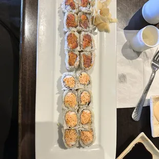a plate of sushi rolls and a plate of chips