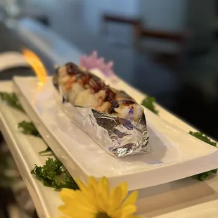 a sushiya on a plate with a flower