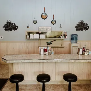 A bar with a peep hole into the cook's space.