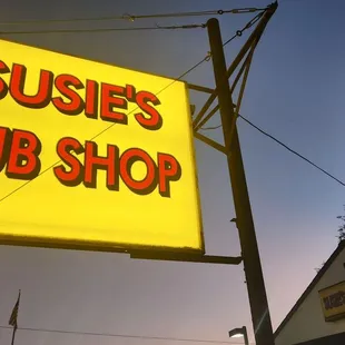 a neon sign for a sub shop
