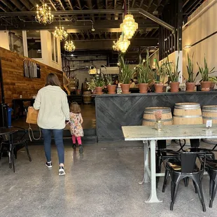 a woman walking through a brewery