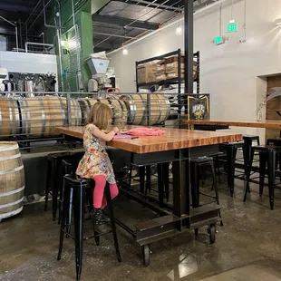 a little girl sitting at a table