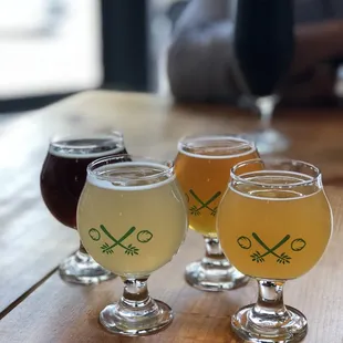 four glasses of beer on a table