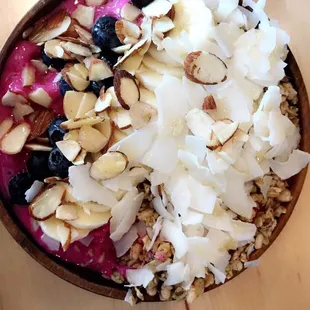 Pitaya bowl, with almonds, granola, coconut chips,banana and blueberries