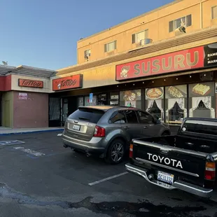 Entrance in strip mall... little parking area with 8+ parking spots