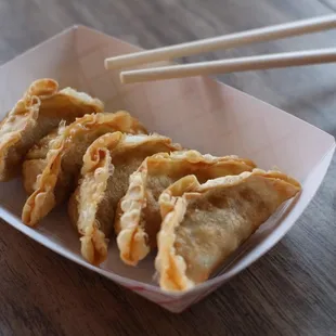 a plate of fried food with chopsticks
