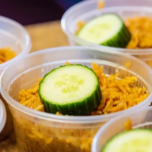cucumbers and rice in plastic containers
