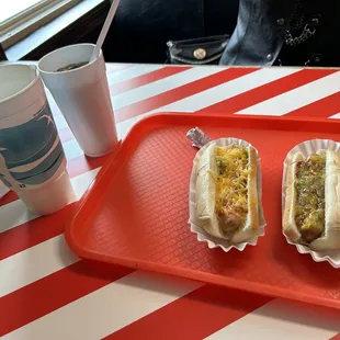 two hot dogs on a red tray