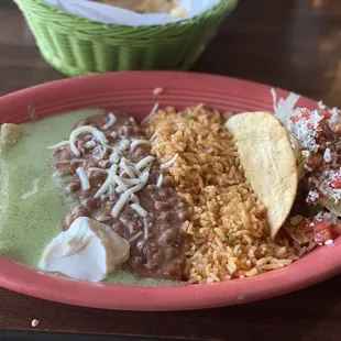 Cheese enchilada chicken taco combo. Delish homemade green sauce. It's not spicy, but it is a unique homemade sauce.