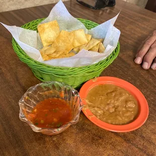 a basket of chips and a bowl of salsa
