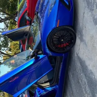 a blue sports car parked in a parking lot