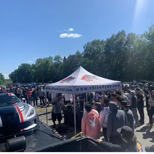 a crowd of people standing under a tent