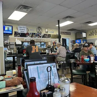 people sitting at tables in a restaurant