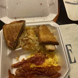 Scrambled eggs with onions and cheese, hash browns bacon and white toast