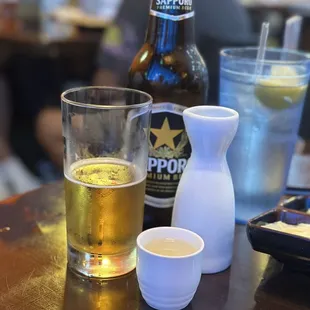 a glass of beer and a salt shaker