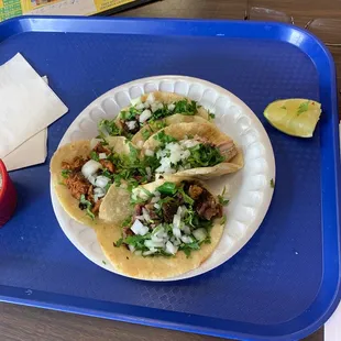 a plate of tacos and an apple