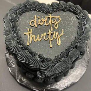 a heart shaped cake with the words cheers thrift on it