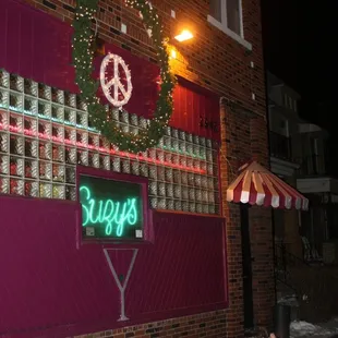 a neon sign on the side of a building