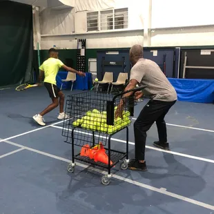 Coach/Owner Daryl with tennis student.