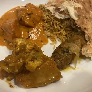 My plate from home of chicken tikka masala , Seekh Kabob, Aloo Gobi, and Lamb Biryani and naan