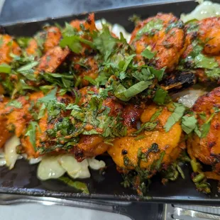 Tandoori Shrimp Jumbo shrimp marinated in a blend of tandoori spices and cooked to perfection in a tandoor.