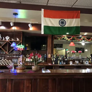 a bar with a flag hanging from the ceiling