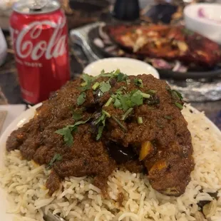 Eggplant rice dish, tandoori pomfret fish, paratha