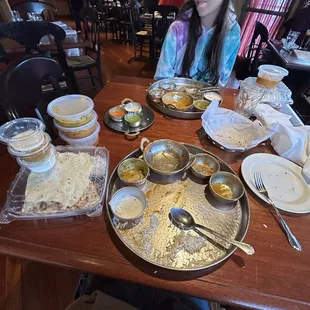 a young girl sitting at a table