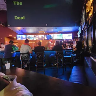 a group of people sitting at a bar