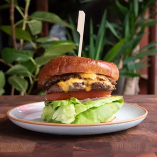 a hamburger with lettuce and cheese