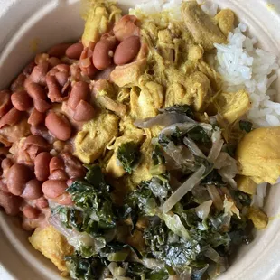 a bowl of rice, beans, and greens