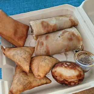 a variety of food items in a styrofoam container