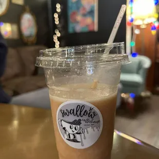 a cup of iced coffee on a table