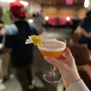 a person holding a drink in a restaurant