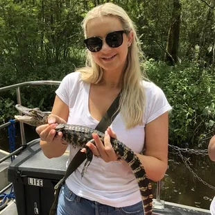 Derrick even jumped in the water to grab a baby gator for us to hold! NOTE:I am holding it lightly but appears like I am squeezing its neck.