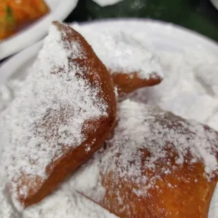 French Beignet with powder sugar all over.