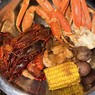 crab legs, corn and potatoes