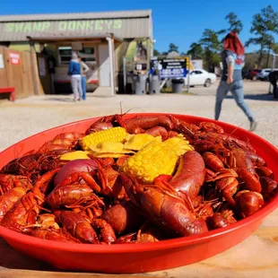 a bowl of crawfish and corn