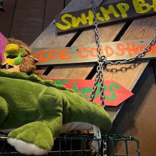 a stuffed alligator in a cage