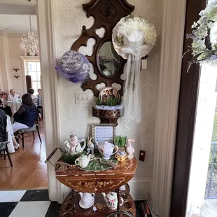 a table with flowers and a mirror