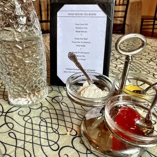 a table setting with a menu and a glass of water