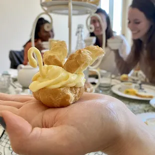 a person holding a pastry in their hand